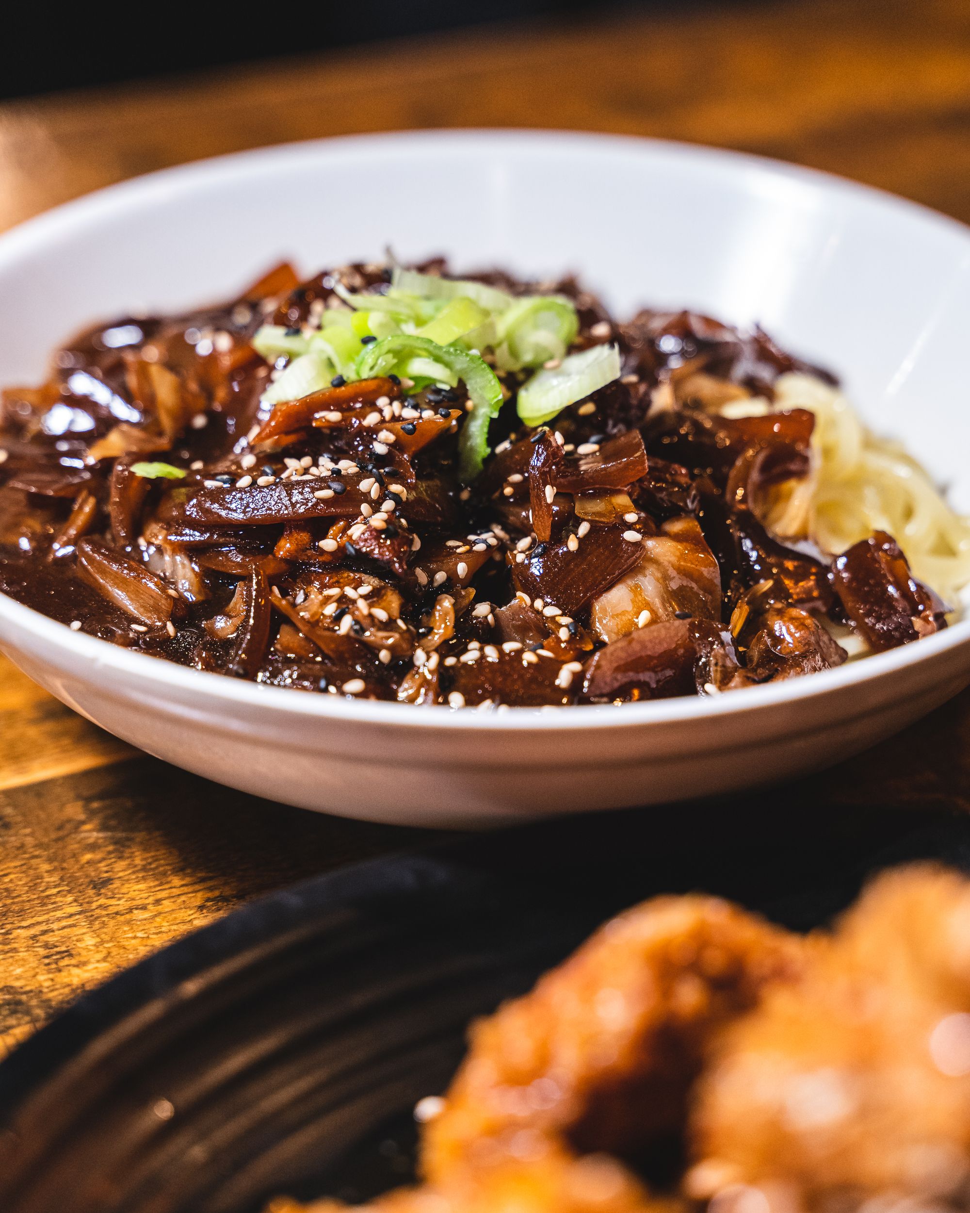 Close up of Korean jajangmyeon noodles in a white bowl