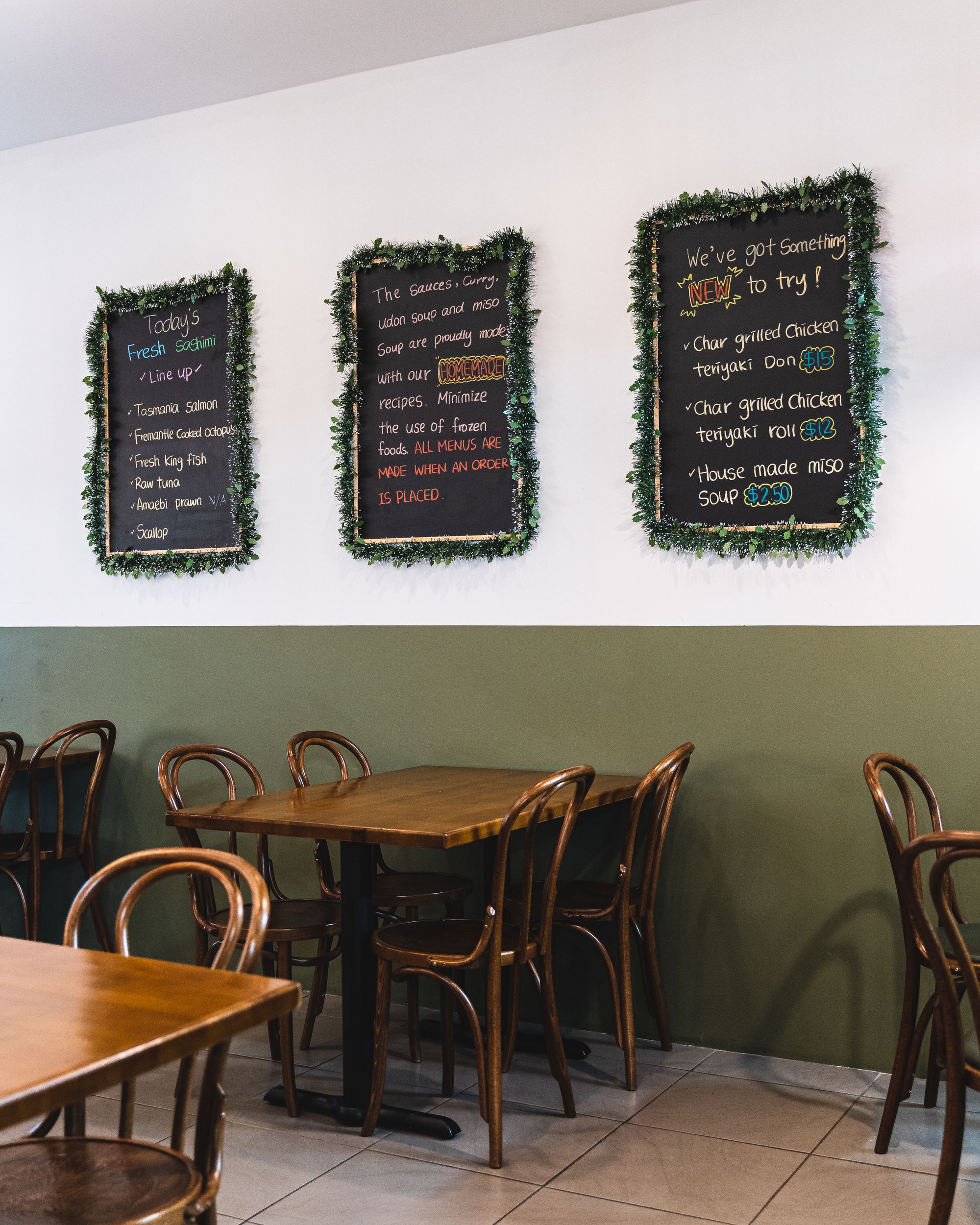 Interior of Kou Sushi showing tables and menus on the wall