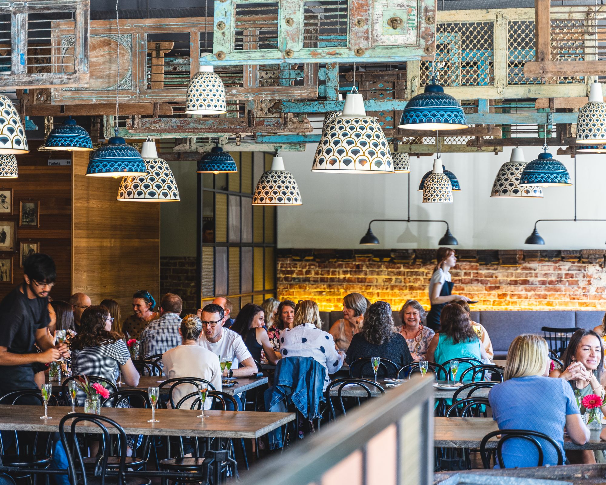 A bustling restaurant with a colourful interior