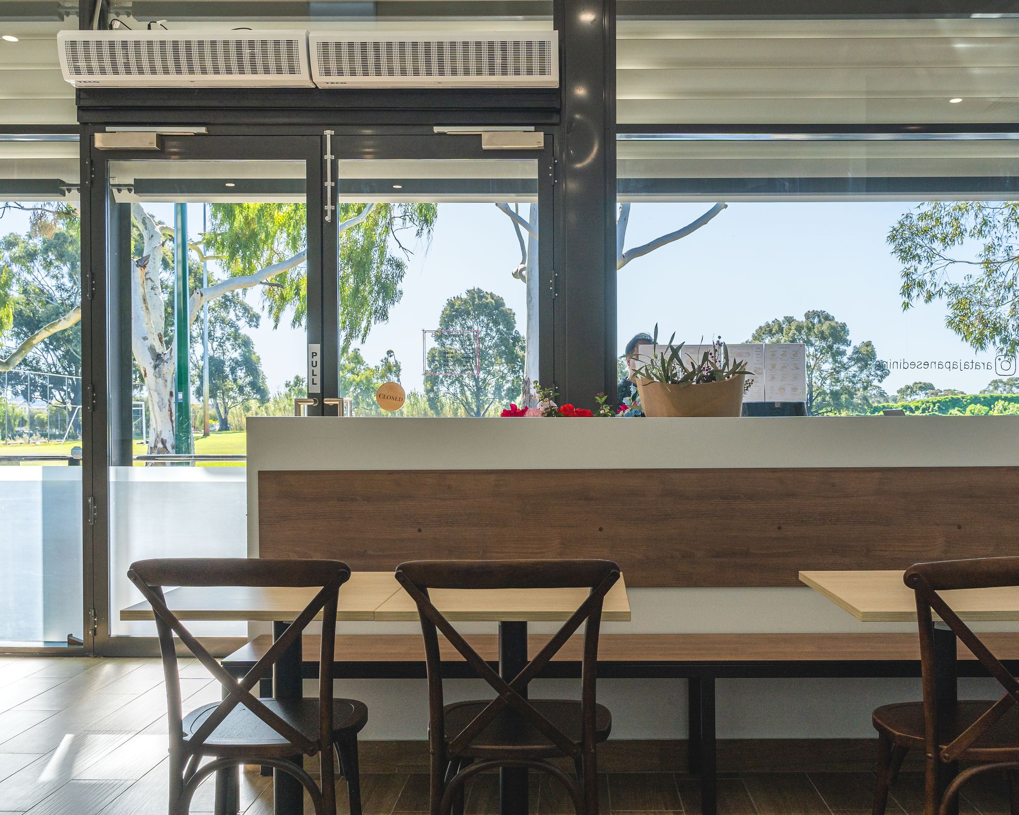 Interior of Arata Japanese Dining showing a seating bench and dining chairs