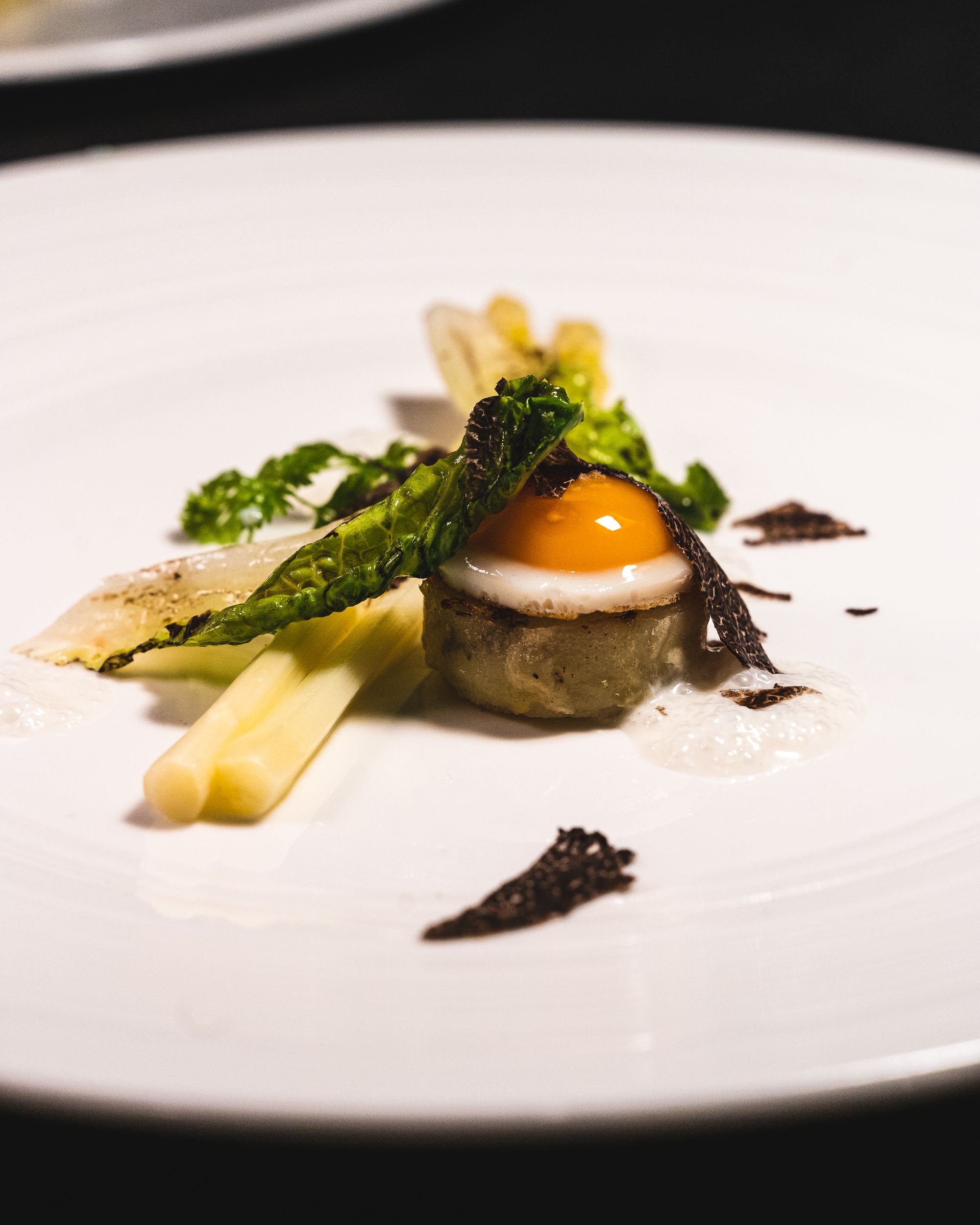 Close up of quail egg with white asparagus