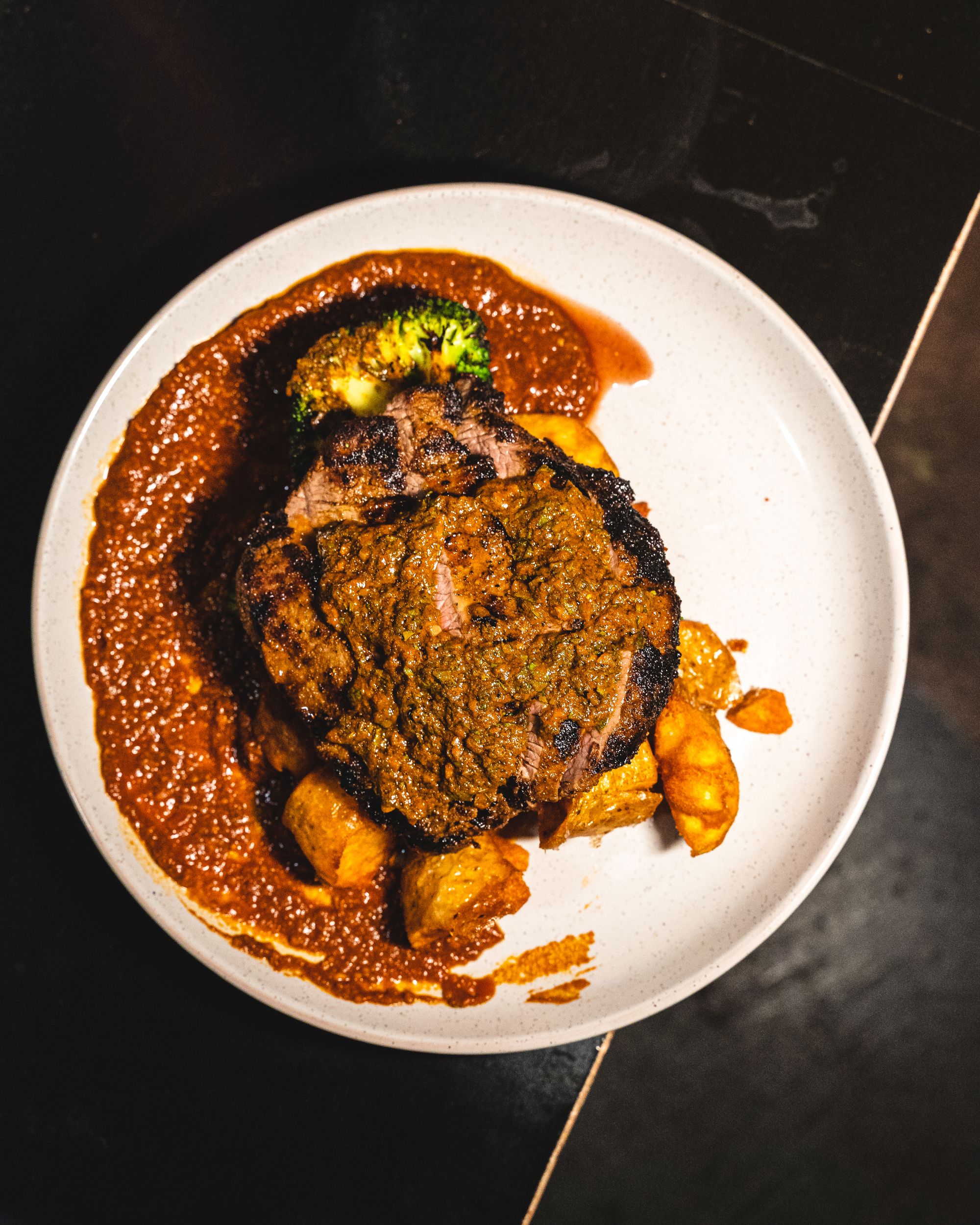 Top down shot of steak with red chimichurri