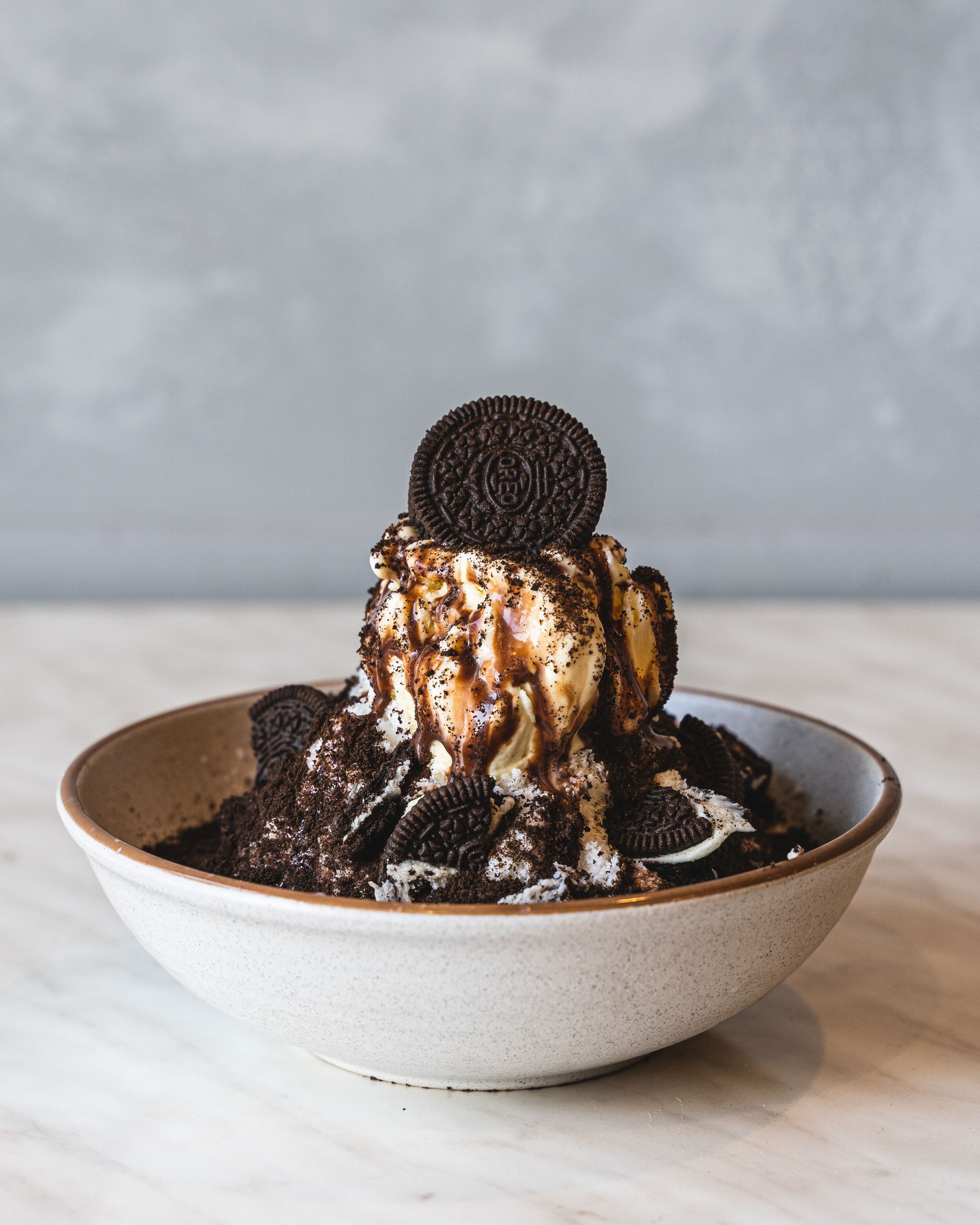 Close up shot of shaved ice with lots of oreo pieces and Nutella chocolate sauce