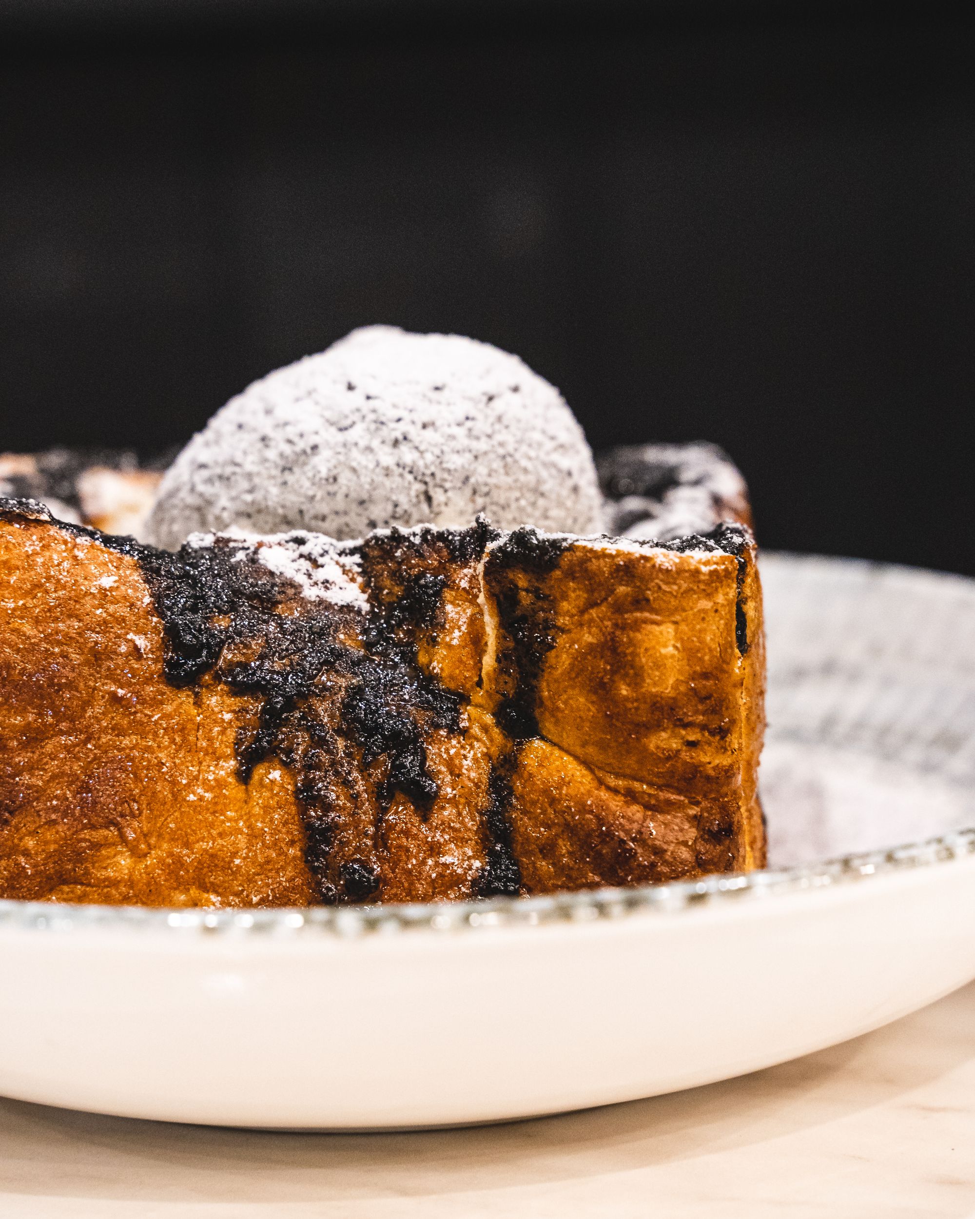 Thick slice of toast with black sesame, black sesame ice-cream and honey