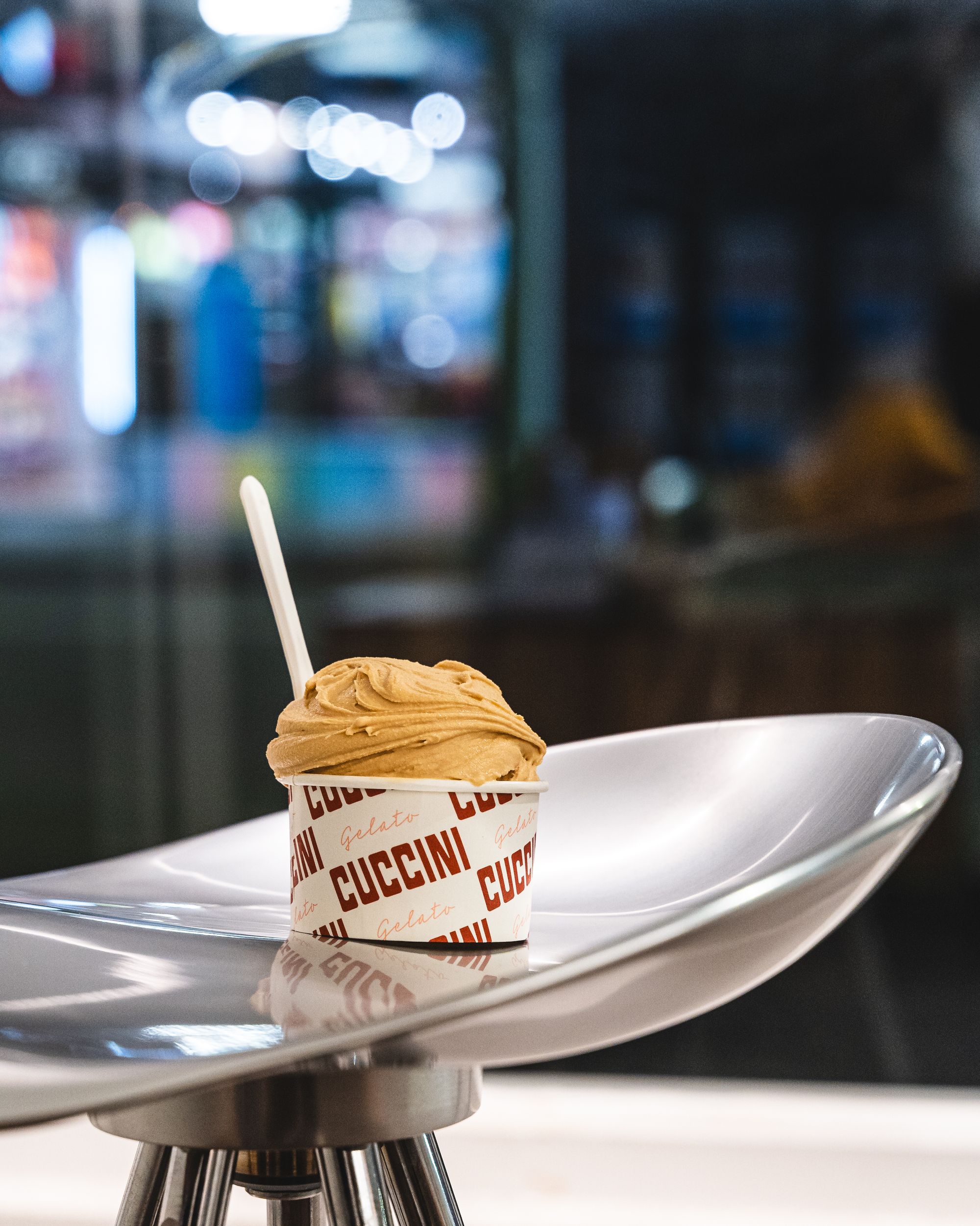 Cup of gelato on-top of a plastic stool