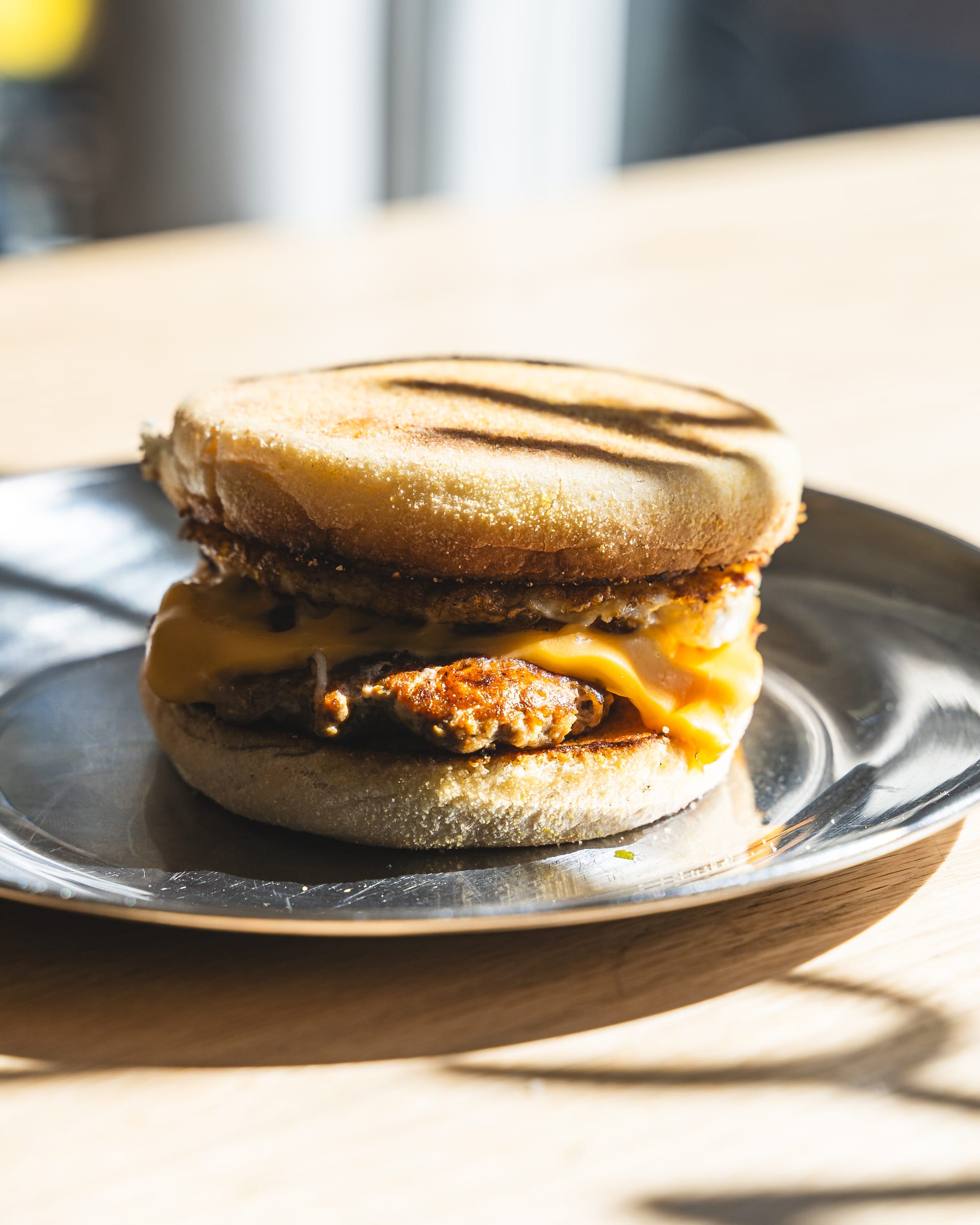 Close up of sausage and cheese in English muffin