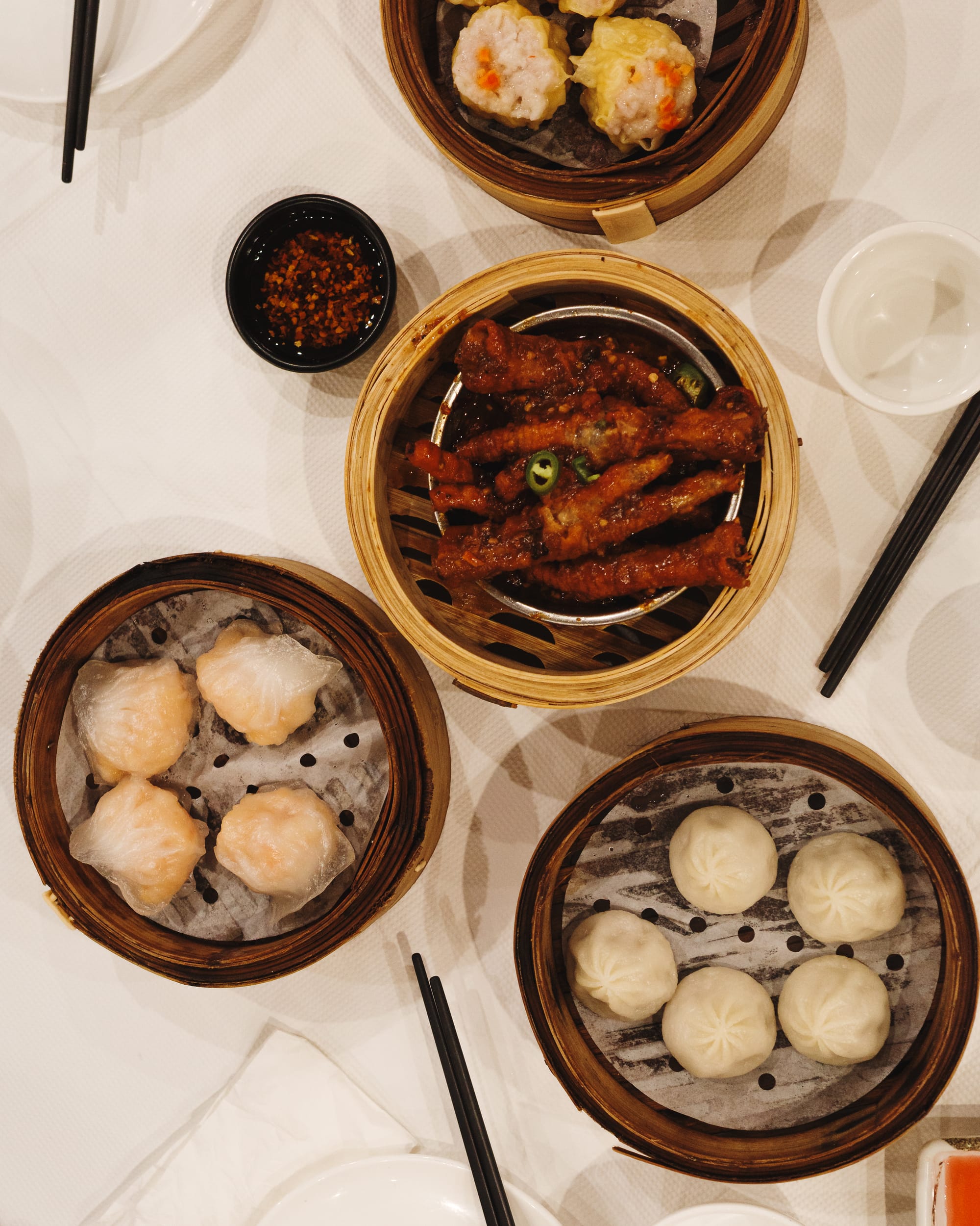 Top down shot of chicken feet, hargao and xiao long bao