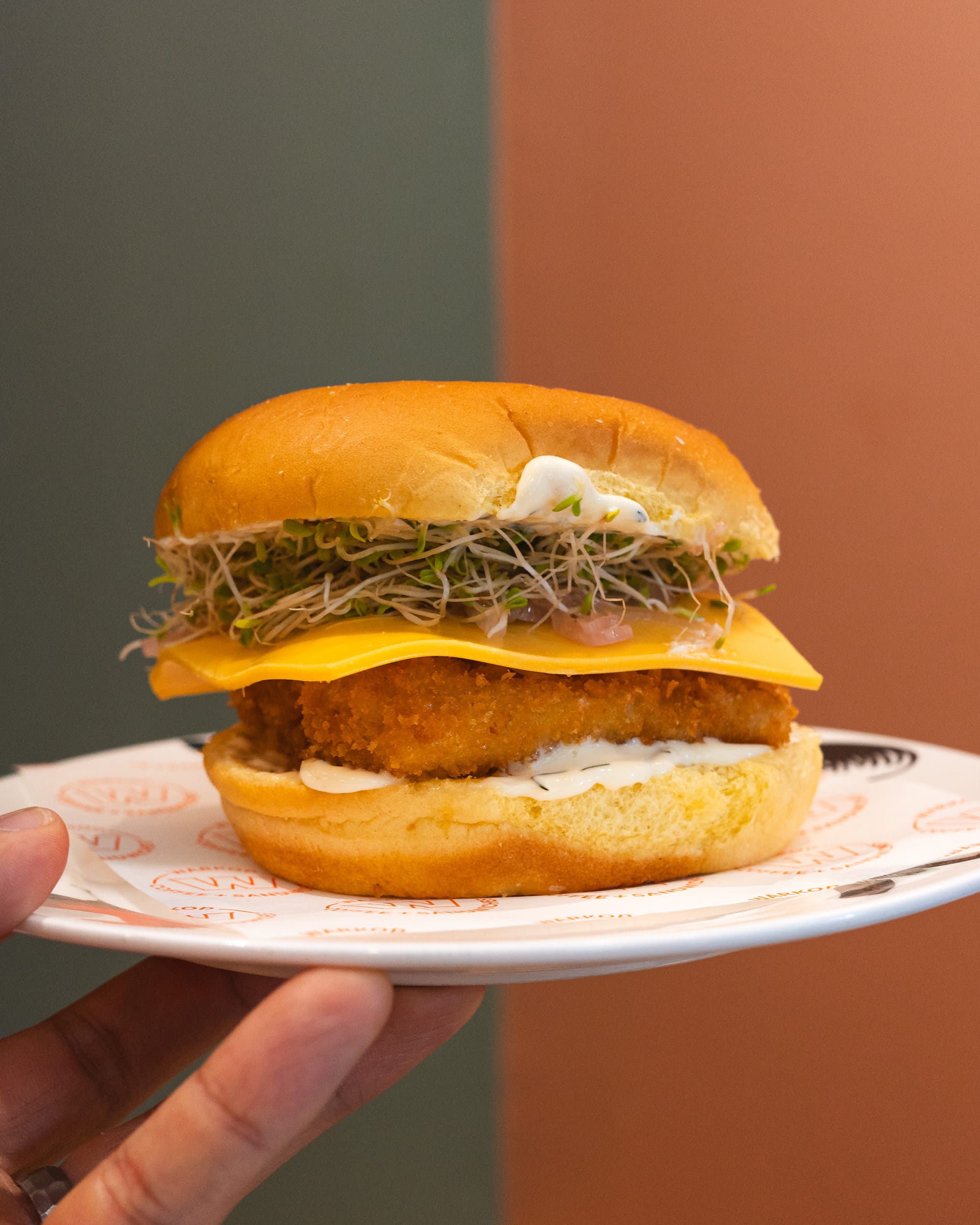 Hand holding a fish sandwich