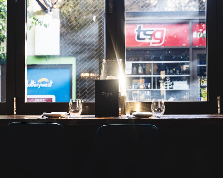 Inside of a restaurant with light reflecting off a glass